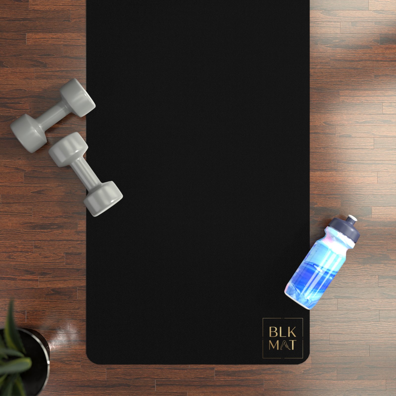 BLKMAT Breath Rings yoga mat, flat lay on a wood floor