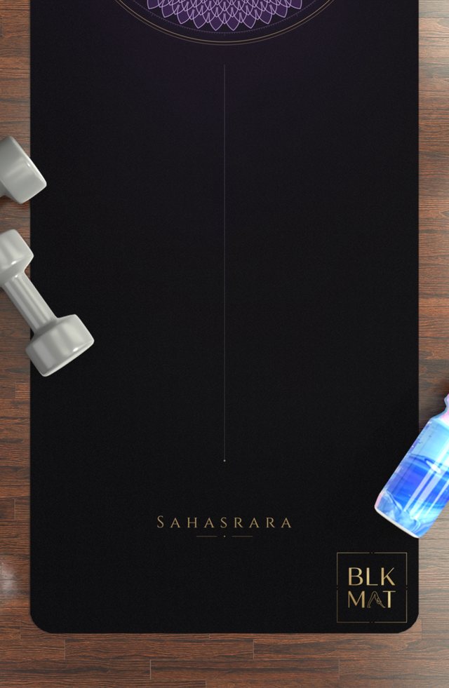 BLKMAT Crown Chakra yoga mat, flat lay on a wood floor