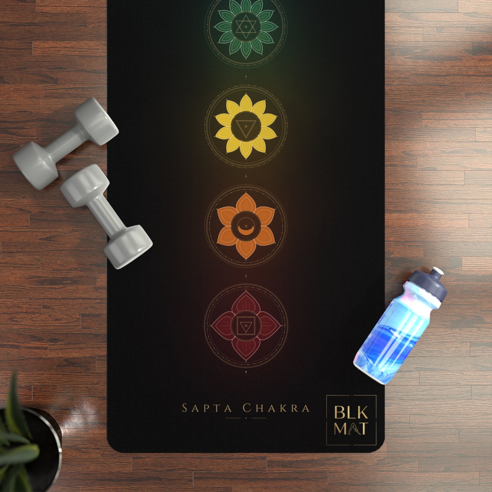 BLKMAT Full Chakra yoga mat, flat lay on a wood floor