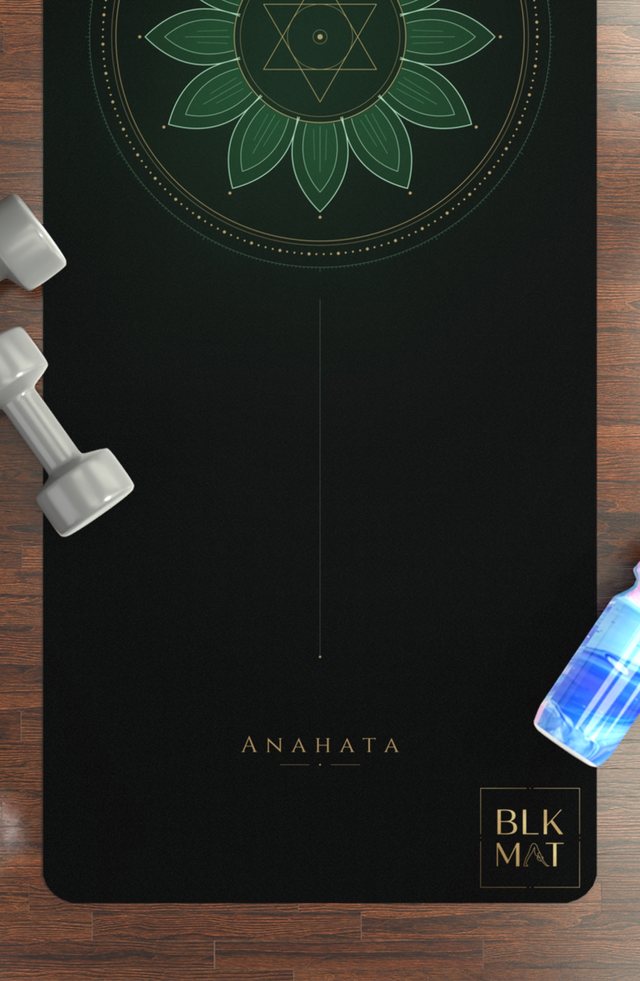 BLKMAT Heart Chakra yoga mat, flat lay on a wood floor