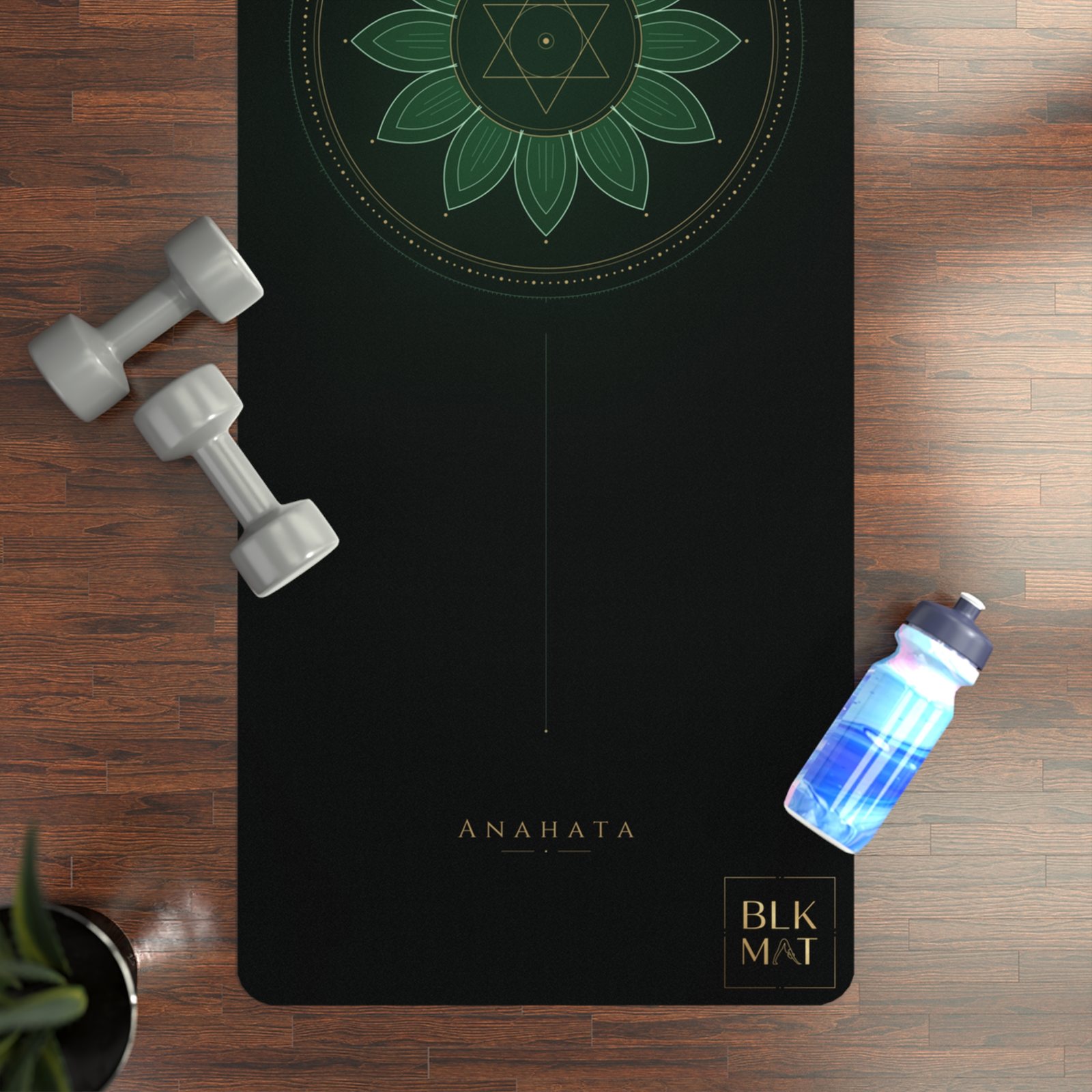 BLKMAT Heart Chakra yoga mat, flat lay on a wood floor