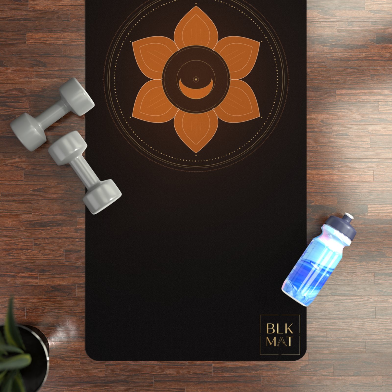 BLKMAT Sacral Chakra yoga mat, flat lay on a wood floor