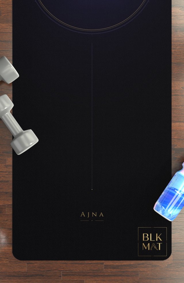 BLKMAT Third Eye Chakra yoga mat, flat lay on a wood floor