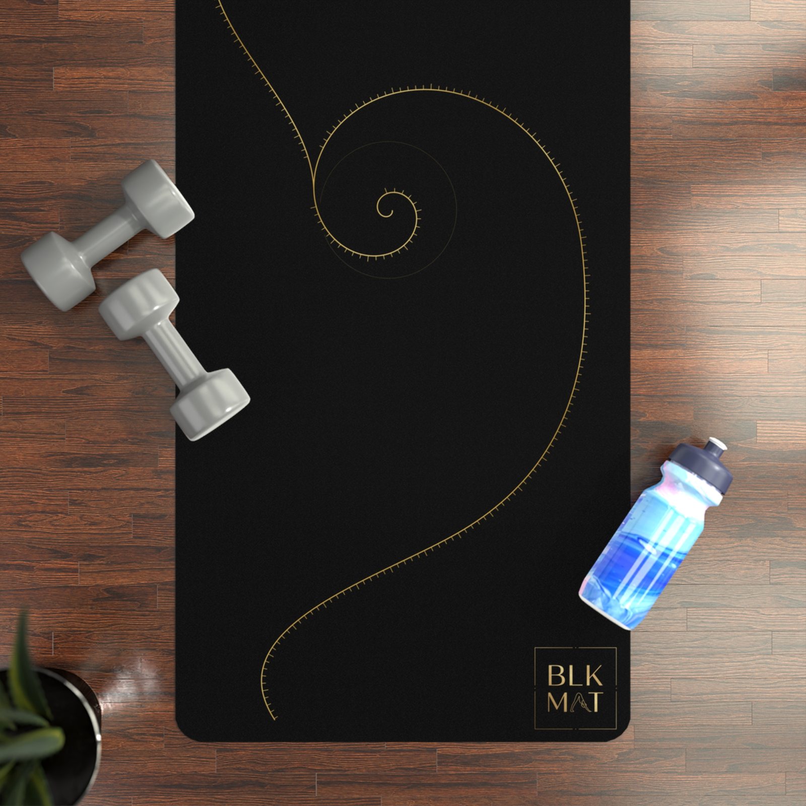 BLKMAT Golden Meridian yoga mat, flat lay on a wood floor