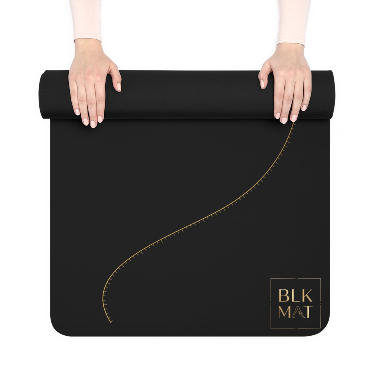 BLKMAT Golden Meridian yoga mat, held up and partly rolled