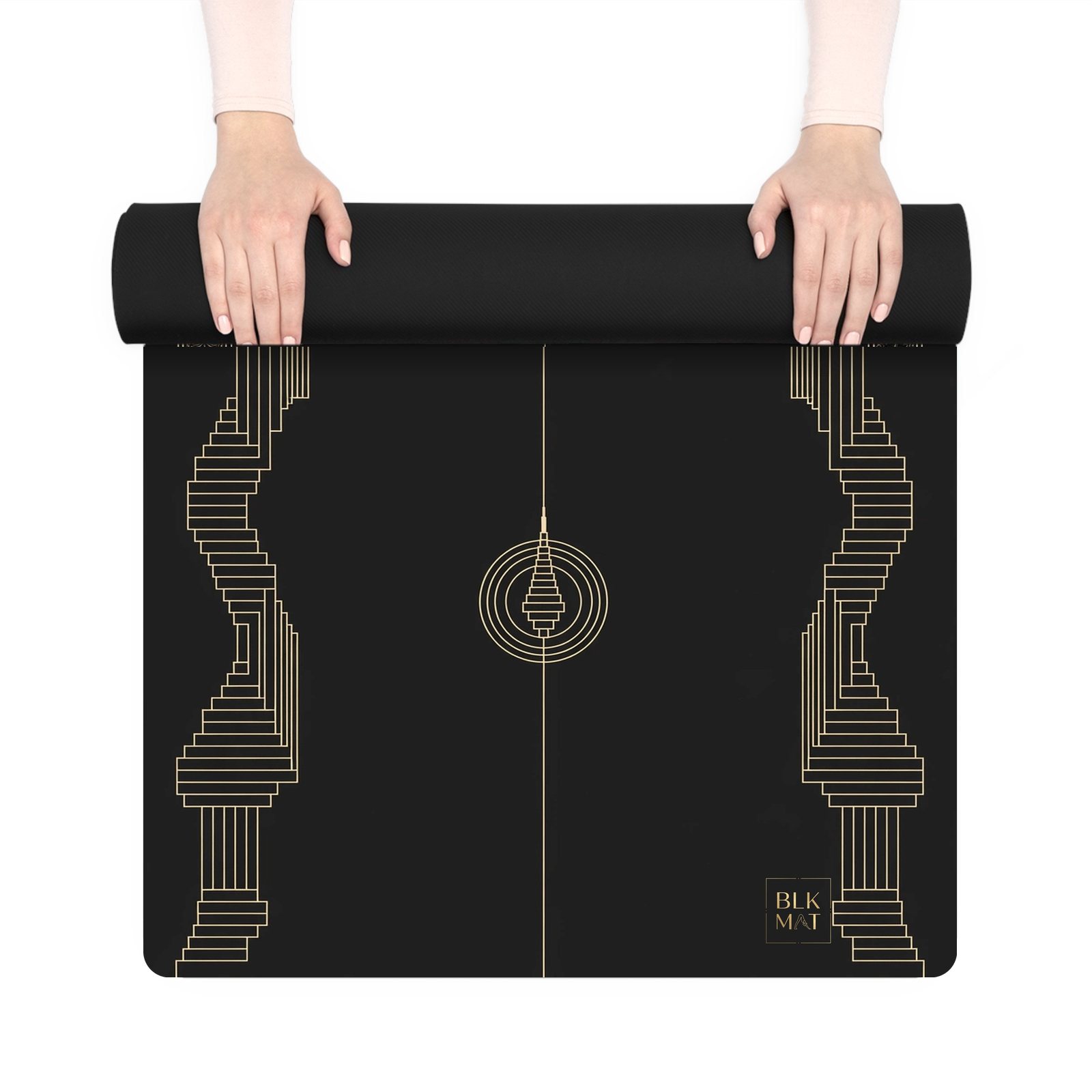 BLKMAT Golden Stupa yoga mat, held up and partly rolled
