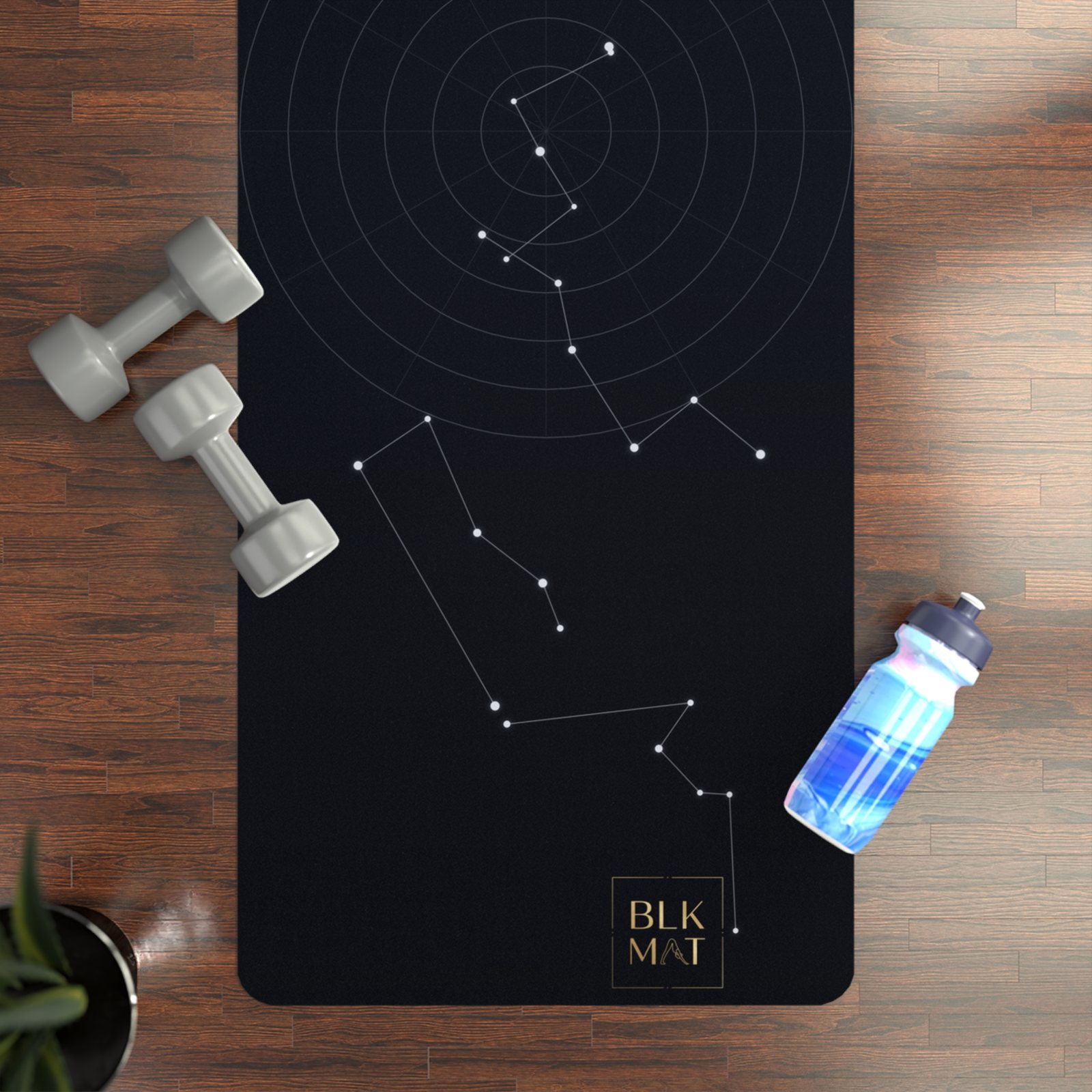 BLKMAT Night Chart yoga mat, flat lay on a wood floor