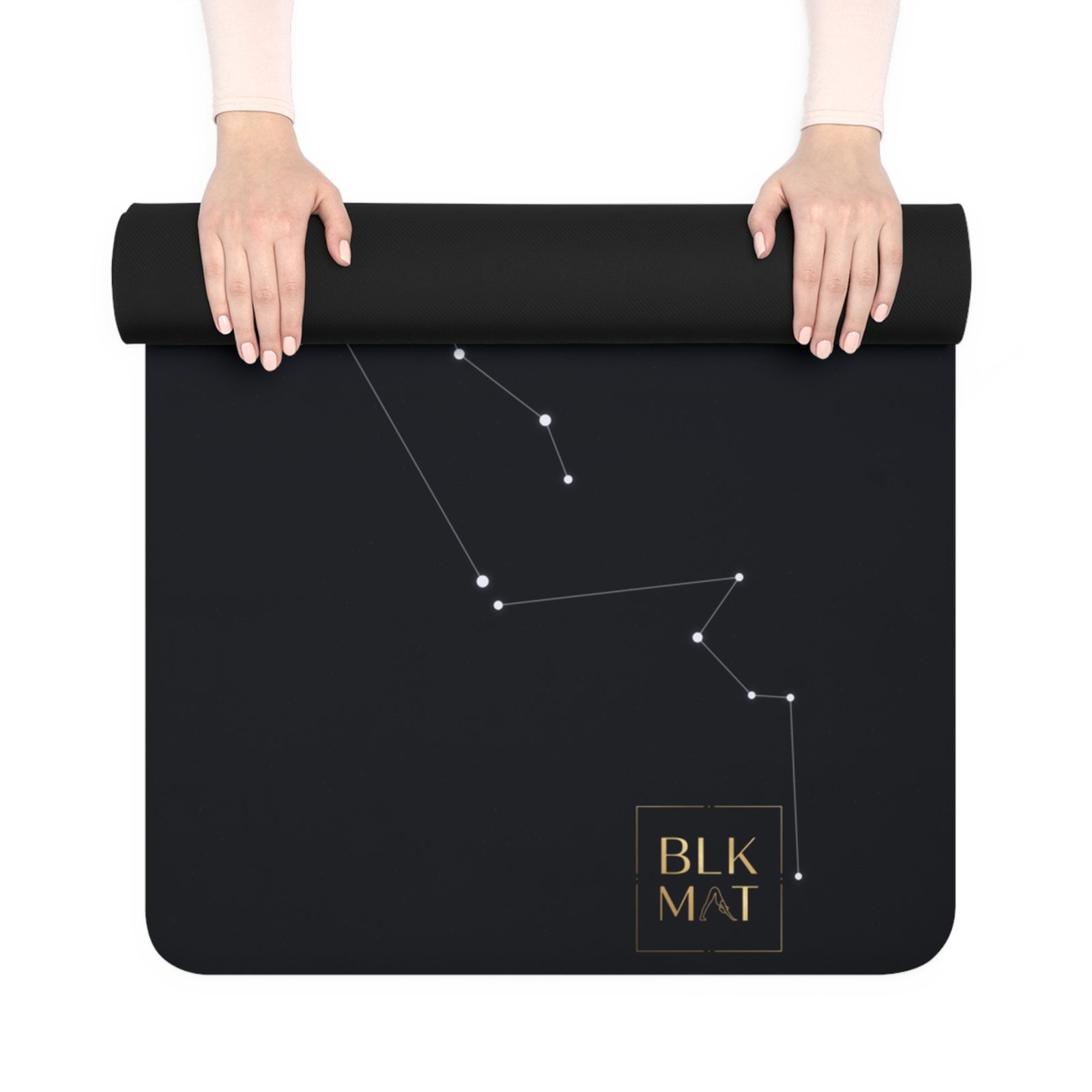 BLKMAT Night Chart yoga mat, held up and partly rolled