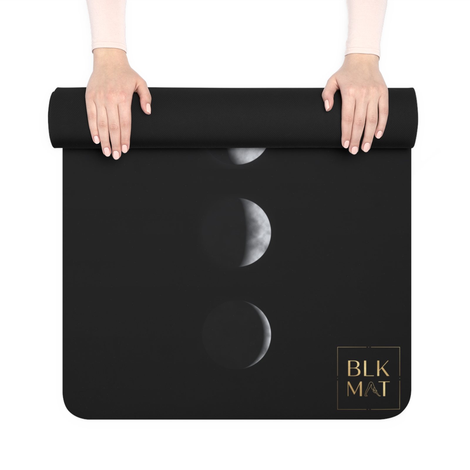 BLKMAT Midnight Moon Phases yoga mat, held up and partly rolled
