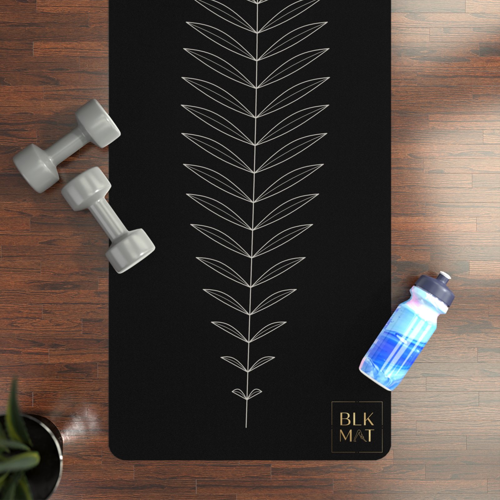 BLKMAT Single-Line Fern yoga mat, flat lay on a wood floor