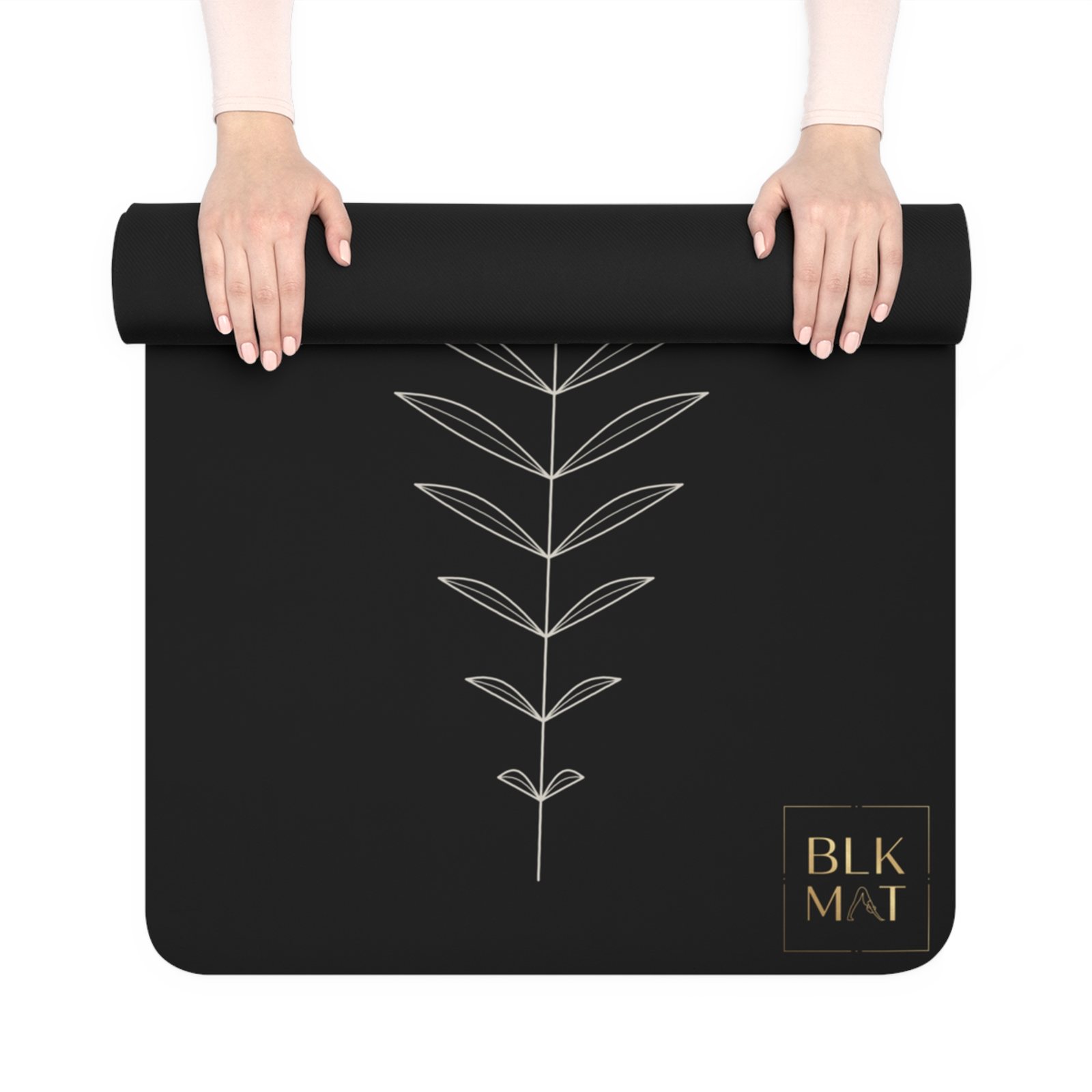 BLKMAT Single-Line Fern yoga mat, held up and partly rolled