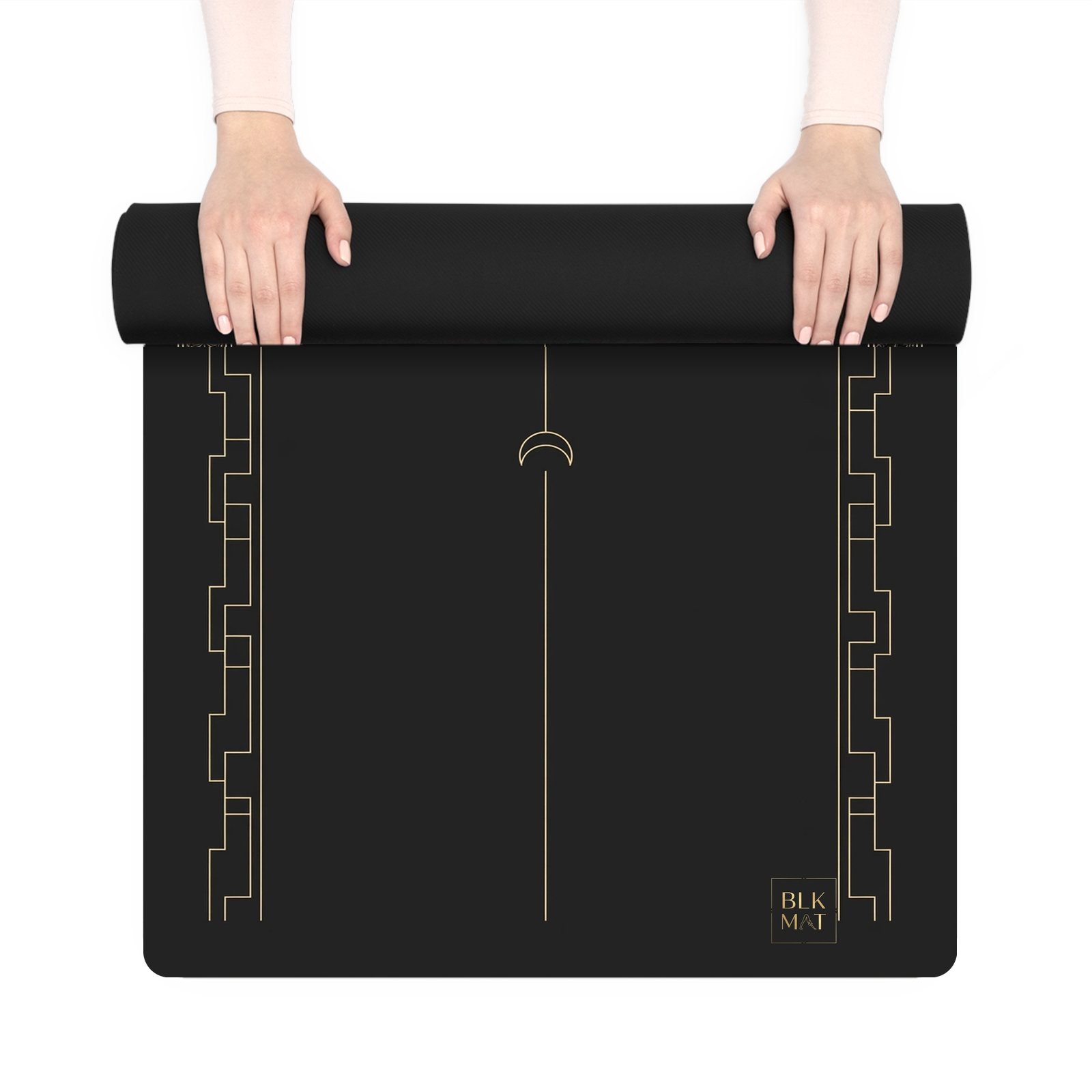 BLKMAT Solstice Arc yoga mat, held up and partly rolled