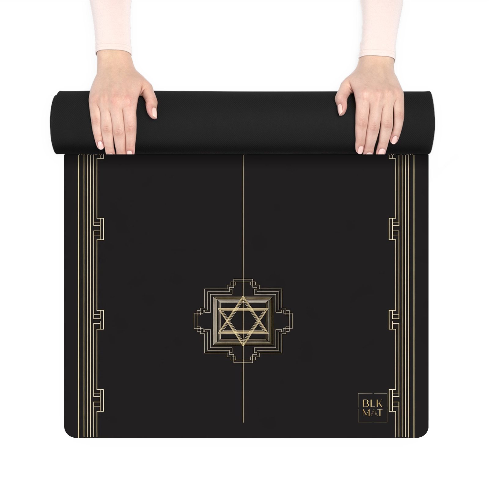 BLKMAT Temple Threshold yoga mat, held up and partly rolled