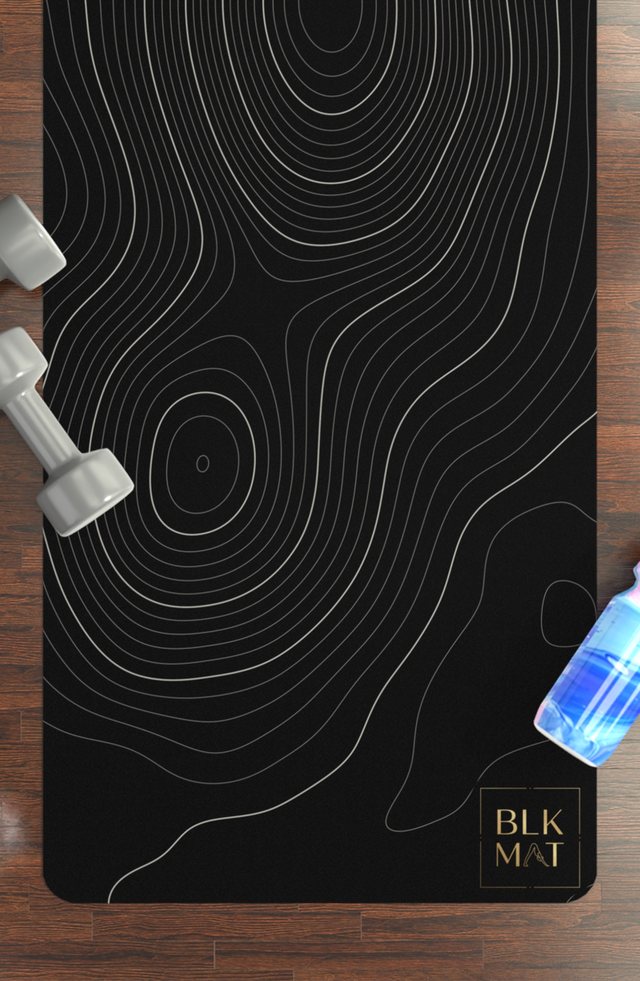 BLKMAT Topographic Contour yoga mat, flat lay on a wood floor