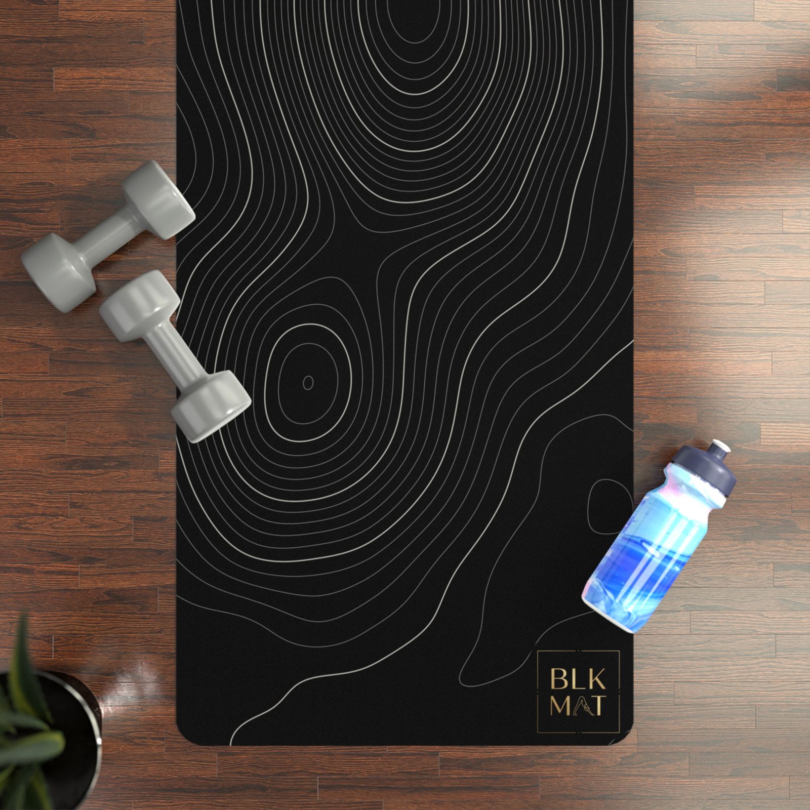 BLKMAT Topographic Contour yoga mat, flat lay on a wood floor