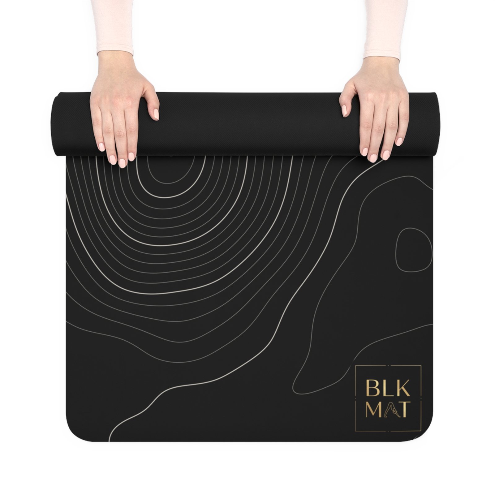 BLKMAT Topographic Contour yoga mat, held up and partly rolled