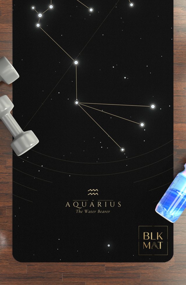 BLKMAT Aquarius Constellation yoga mat, flat lay on a wood floor