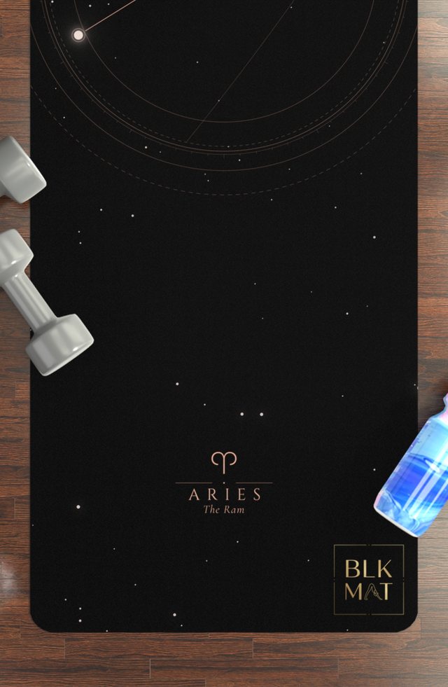 BLKMAT Aries Constellation yoga mat, flat lay on a wood floor