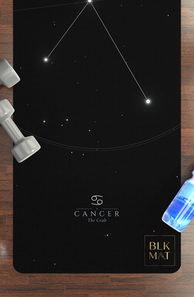BLKMAT Cancer Constellation yoga mat, flat lay on a wood floor