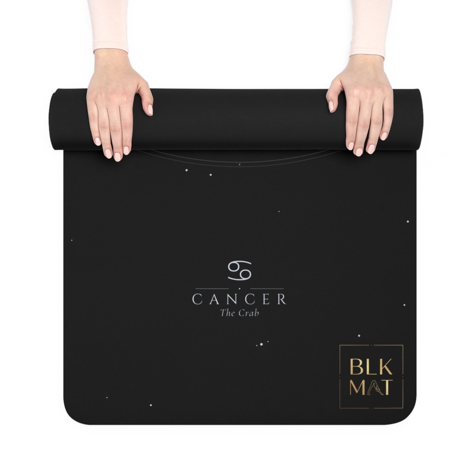 BLKMAT Cancer Constellation yoga mat, held up and partly rolled