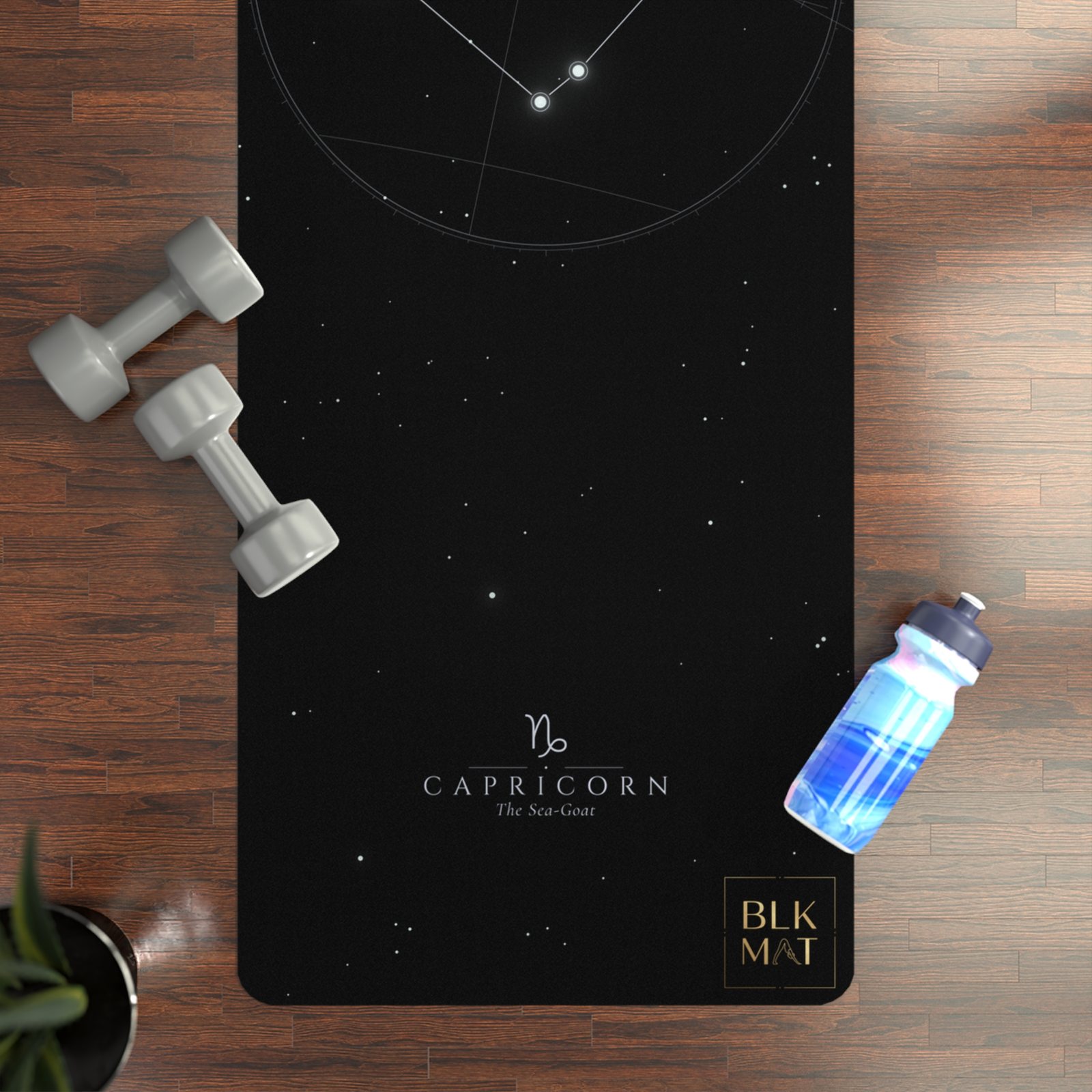 BLKMAT Capricorn Constellation yoga mat, flat lay on a wood floor
