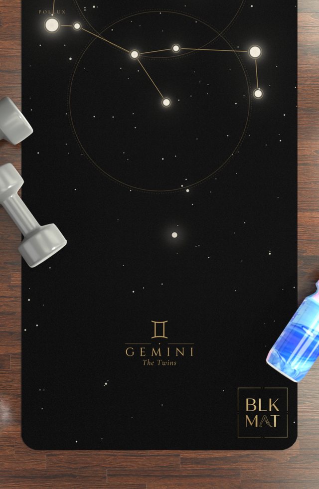 BLKMAT Gemini Constellation yoga mat, flat lay on a wood floor