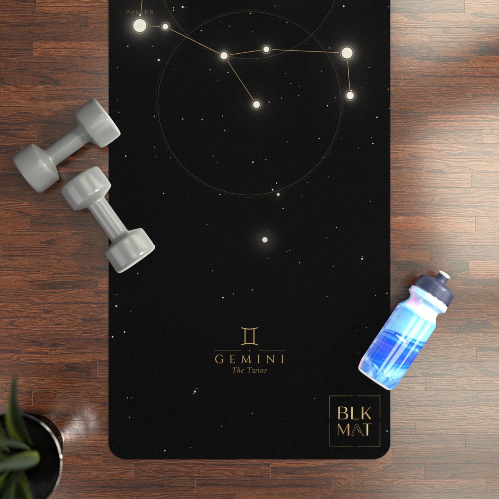 BLKMAT Gemini Constellation yoga mat, flat lay on a wood floor