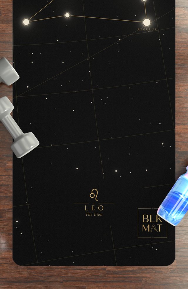 BLKMAT Leo Constellation yoga mat, flat lay on a wood floor