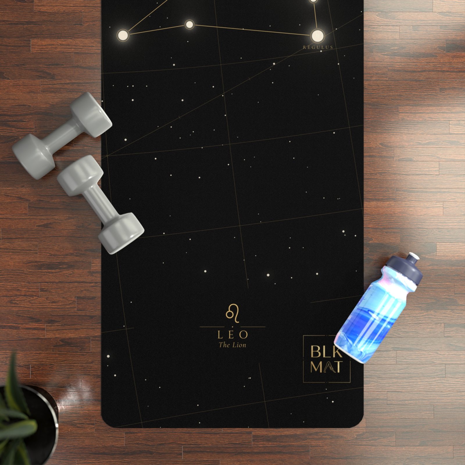 BLKMAT Leo Constellation yoga mat, flat lay on a wood floor