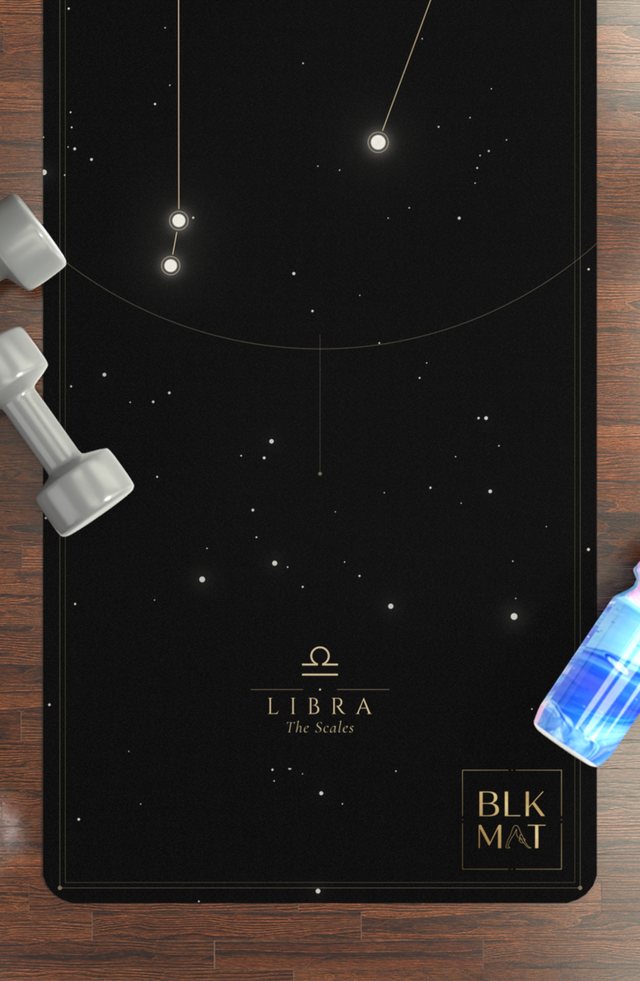 BLKMAT Libra Constellation yoga mat, flat lay on a wood floor
