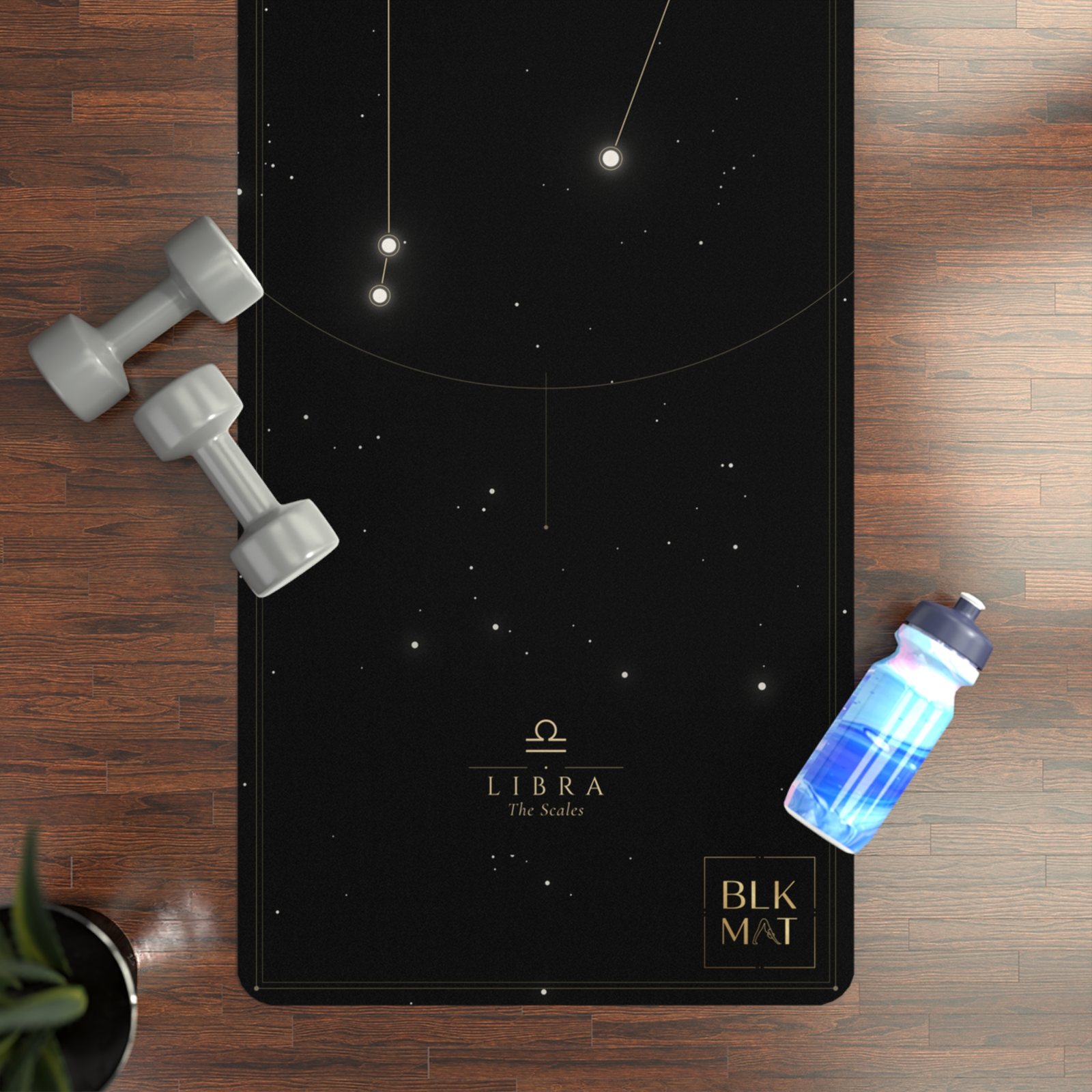 BLKMAT Libra Constellation yoga mat, flat lay on a wood floor