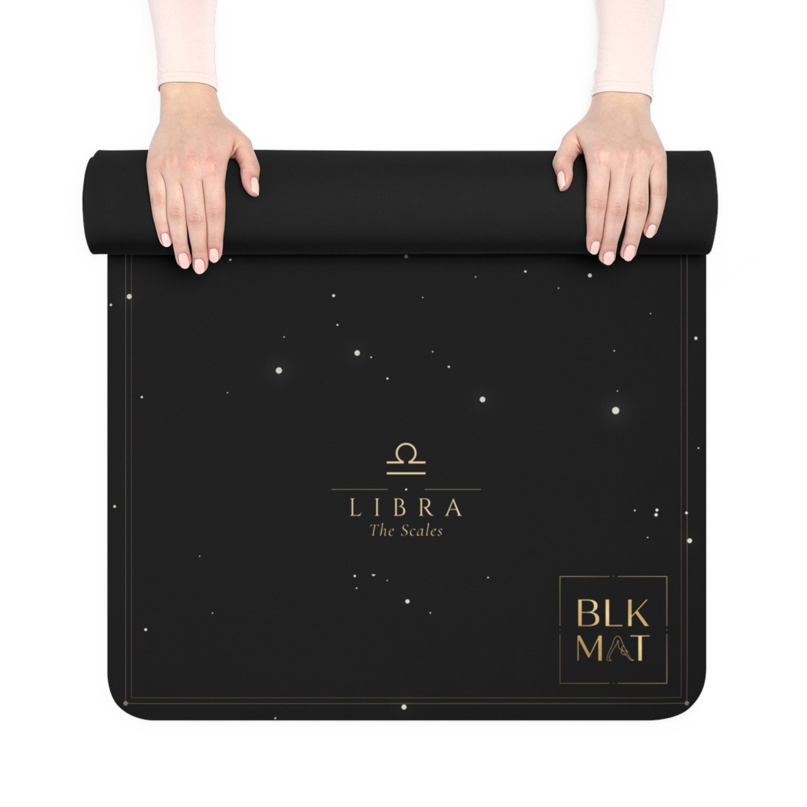 BLKMAT Libra Constellation yoga mat, held up and partly rolled