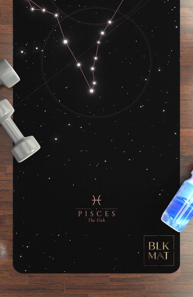 BLKMAT Pisces Constellation yoga mat, flat lay on a wood floor