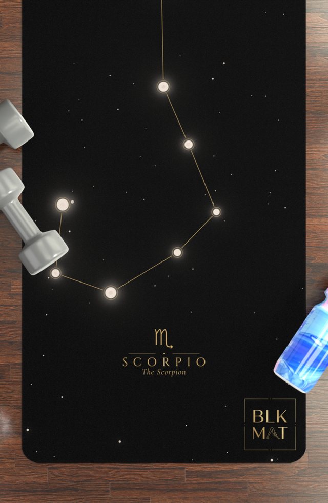 BLKMAT Scorpio Constellation yoga mat, flat lay on a wood floor