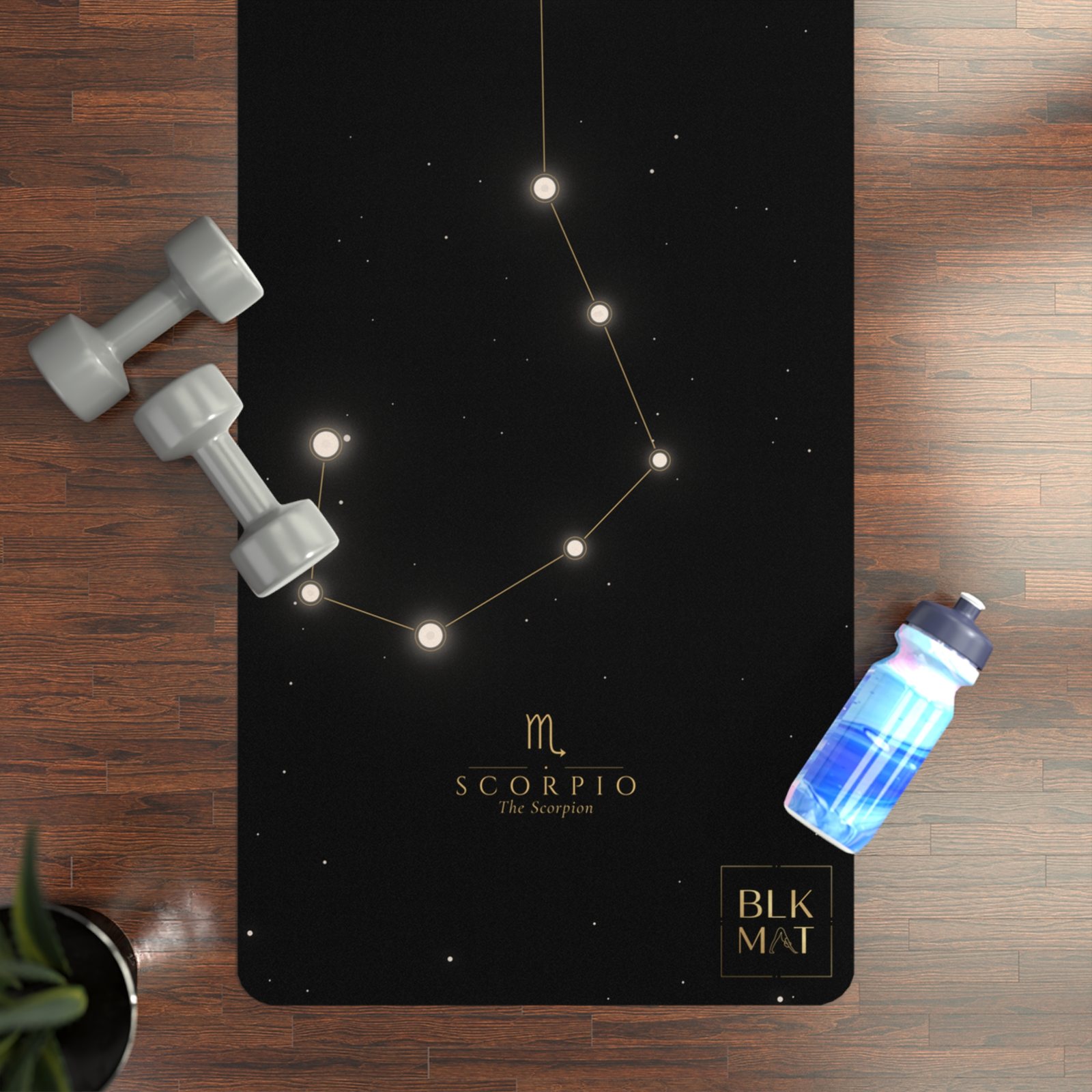 BLKMAT Scorpio Constellation yoga mat, flat lay on a wood floor