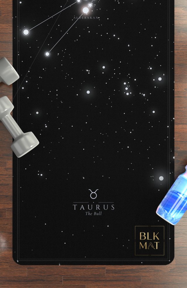 BLKMAT Taurus Constellation yoga mat, flat lay on a wood floor