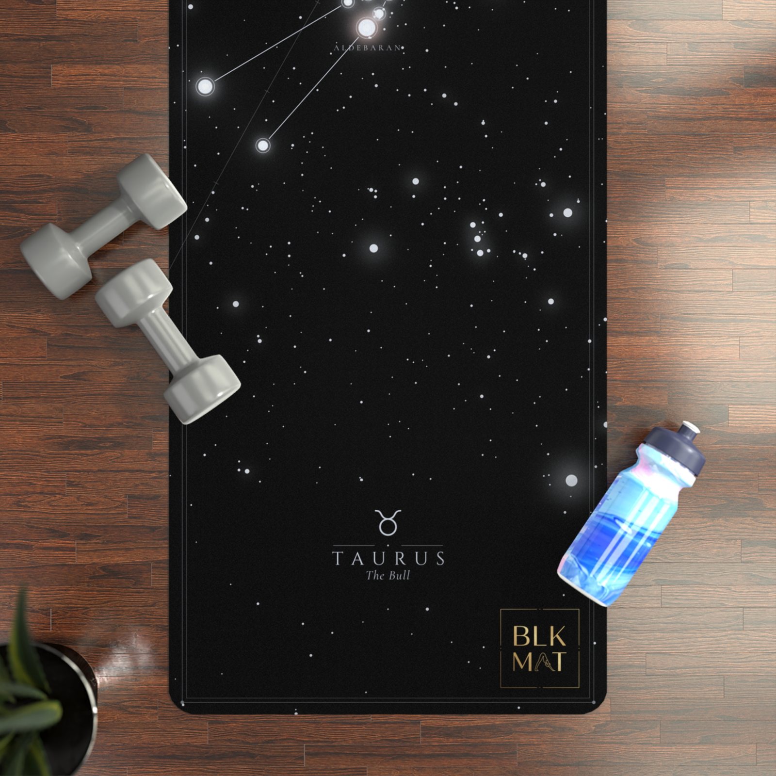 BLKMAT Taurus Constellation yoga mat, flat lay on a wood floor