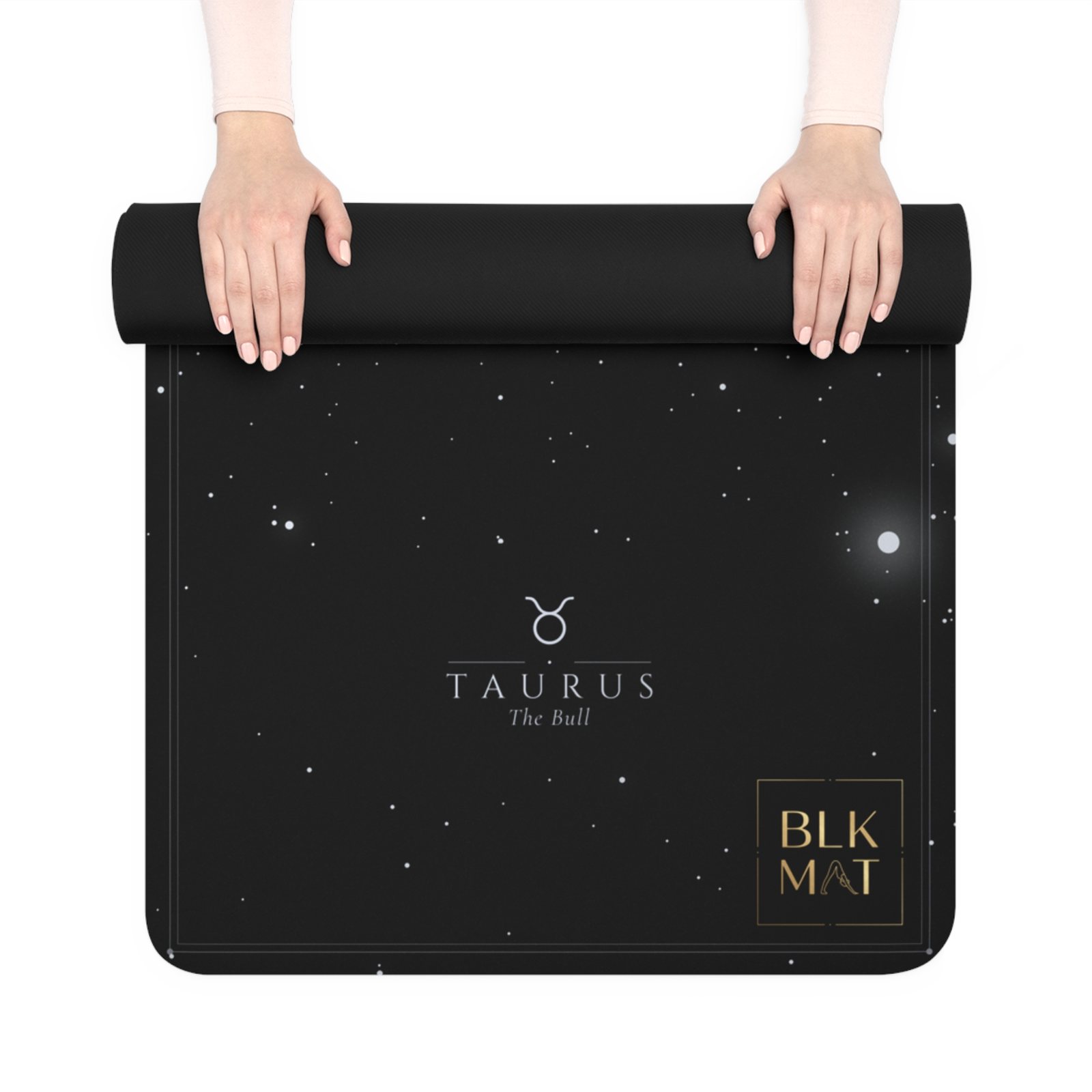 BLKMAT Taurus Constellation yoga mat, held up and partly rolled