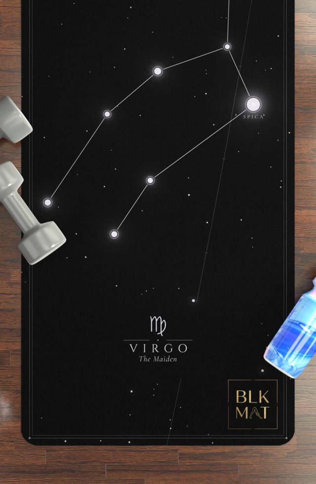 BLKMAT Virgo Constellation yoga mat, flat lay on a wood floor