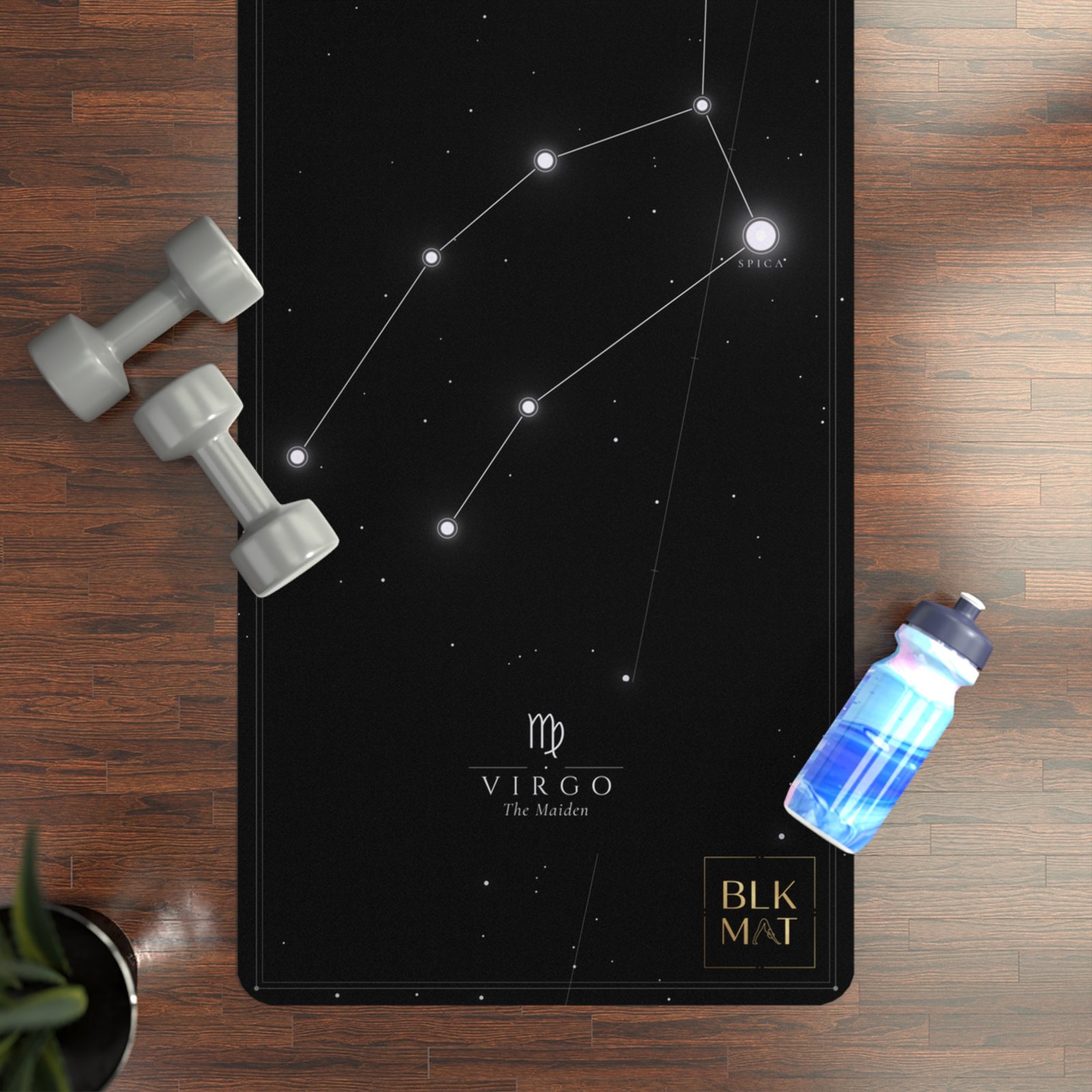 BLKMAT Virgo Constellation yoga mat, flat lay on a wood floor