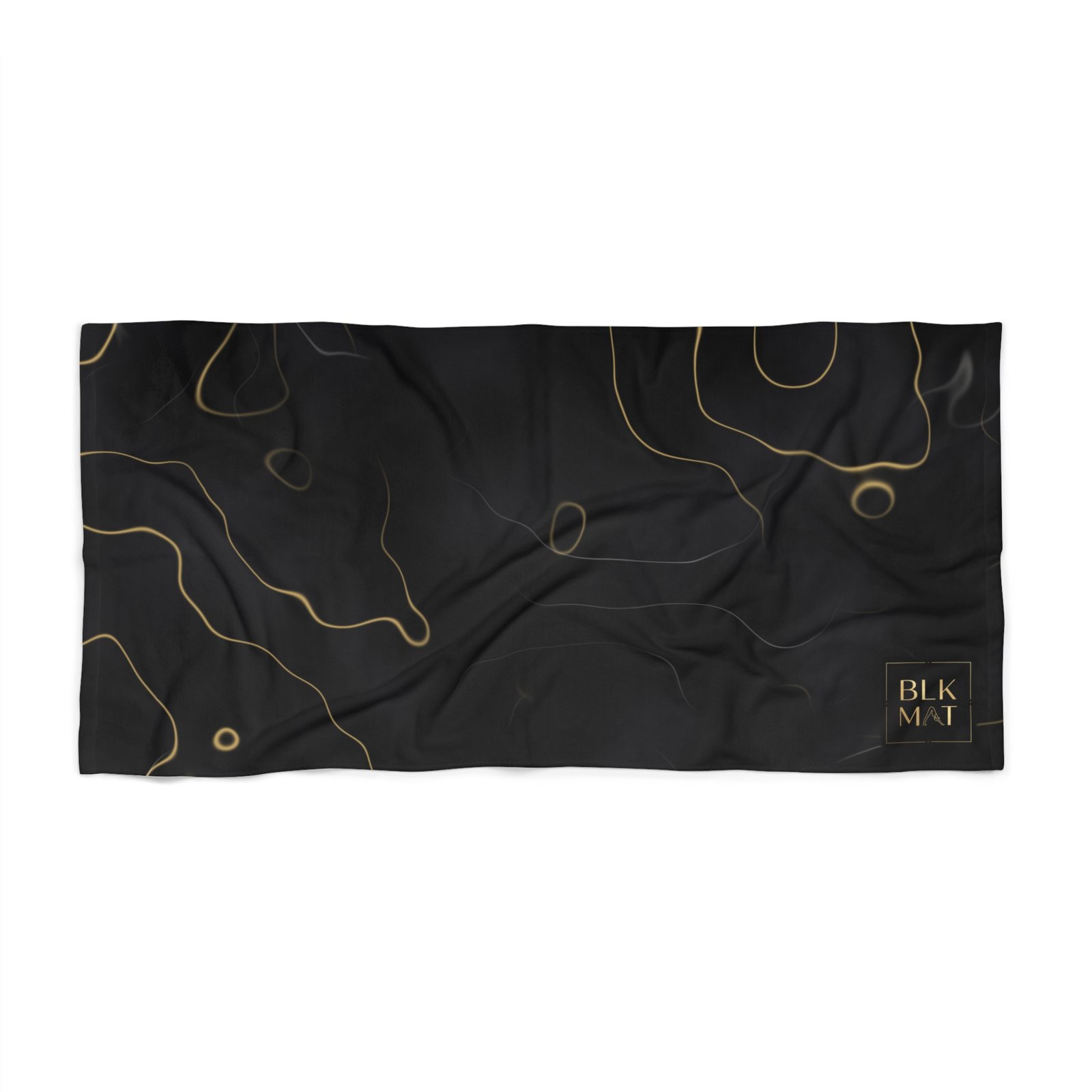Beach towel covered in smoky black marble with winding gold veins and a small gold BLKMAT logo in the bottom-right corner.