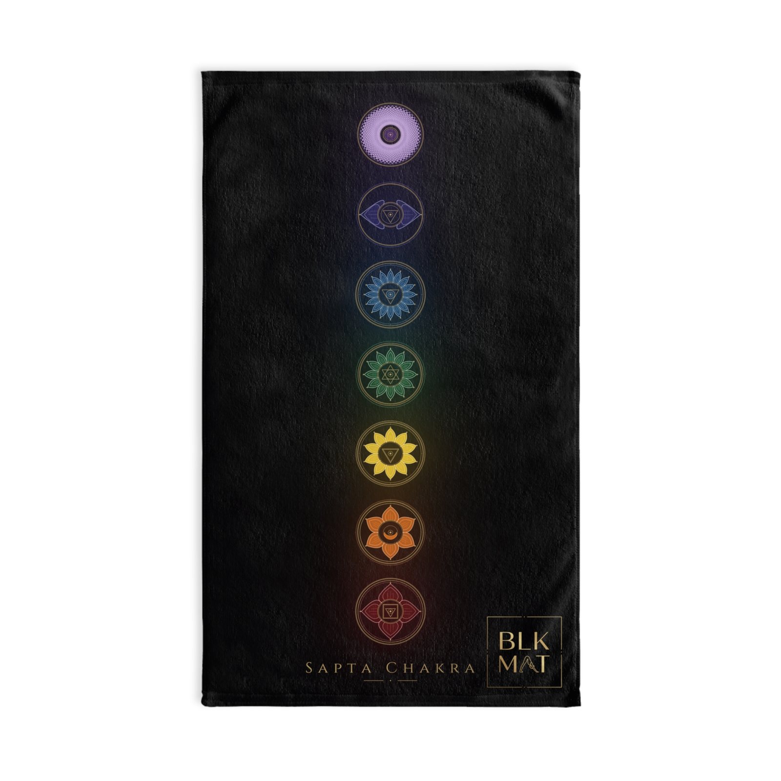 Black hand towel with seven rainbow-colored chakra emblems stacked down its length, the caption Sapta Chakra, and a small gold BLKMAT logo in the bottom corner.