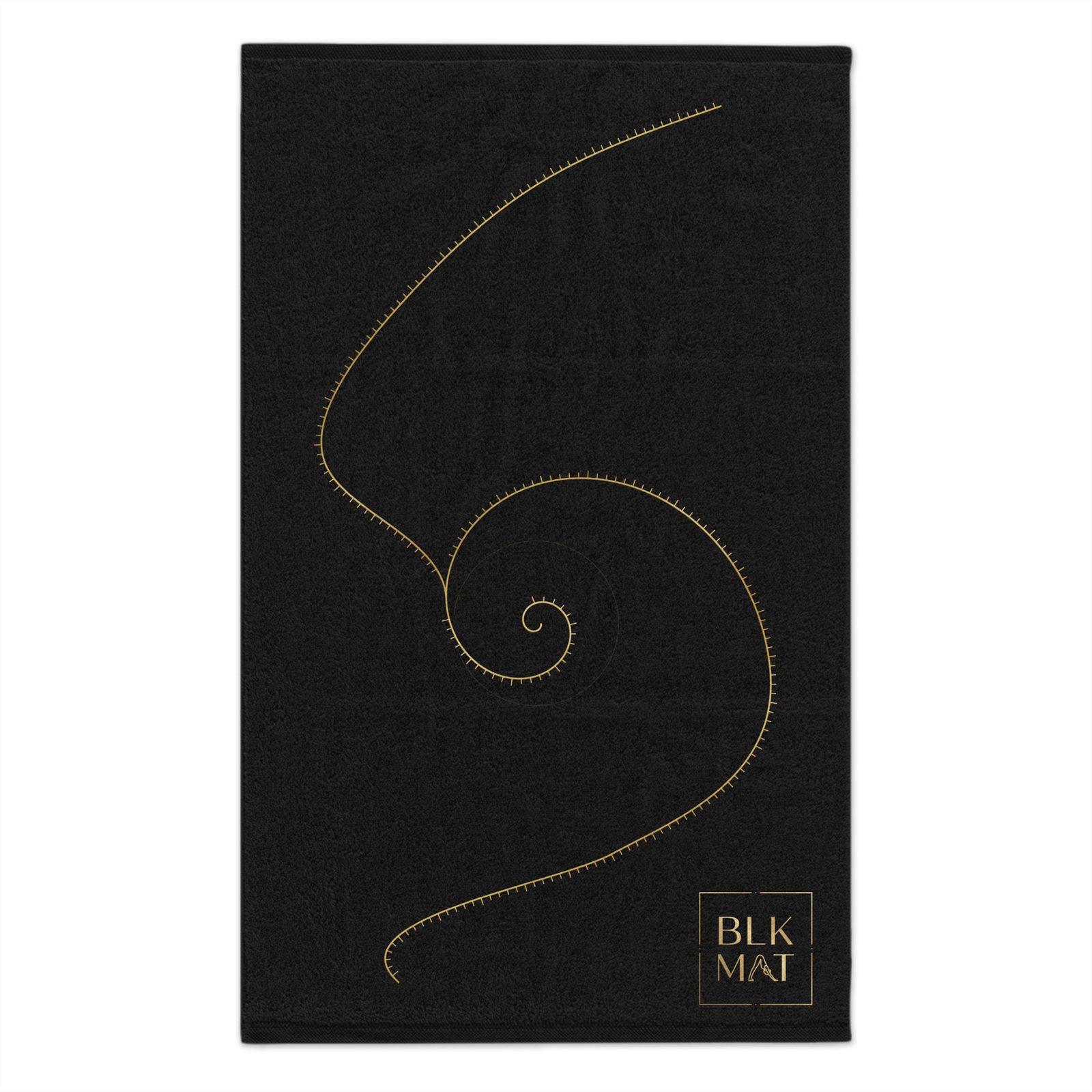 Small black gym towel with a fine gold golden-ratio spiral running down its length and a small gold BLKMAT logo in the bottom corner.