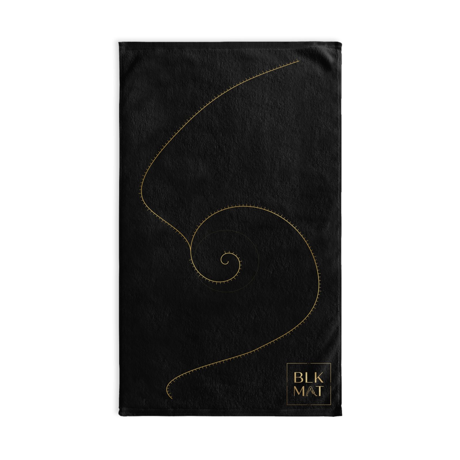 Black hand towel with a fine gold golden-ratio spiral running down its length and a small gold BLKMAT logo in the bottom corner.
